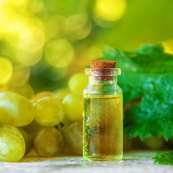 Grape seed oil in a bottle. Selective focus. Grape seed oil in a bottle. Selective focus. Nature.